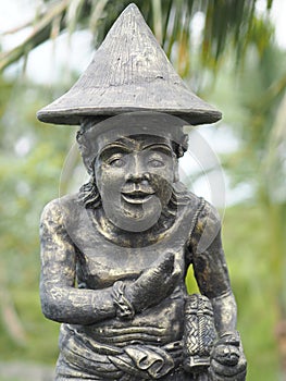 Statuette at the entrance of a rice field protecting crops, harvests and men