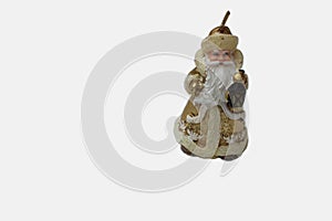 Statuette of Santa Claus on a white background. Golden santa claus candle isolated on white. Saint Nicholas in beige color with a