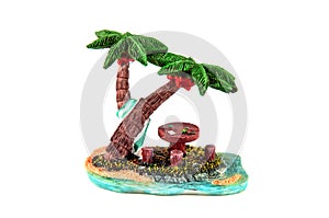 Statuette - wooden picnic table under the palm trees on the beach