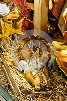 Statuettes of Mary, Joseph and the newborn baby Jesus in the hay, A Christmas crib