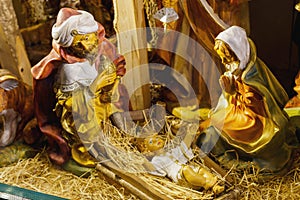 Statuettes of Mary, Joseph and the newborn baby Jesus in the hay, A Christmas crib