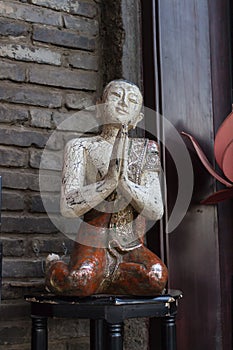 Statute of a Buddhist monk on a stool
