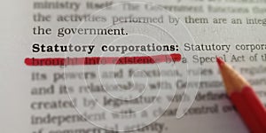 statutory corporations words displaying on book article underlined in red color line