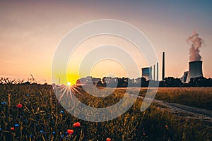 Staudinger coal-fired power plant, Bavaria, Germany. In the morning, sunrise with landscape, everything is reflected in a puddle