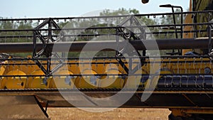 Stavropol, RUSSIA - JULY 15 2020: Close-up Modern combine harvester collects ripe wheat leaving behind a cloud of dust