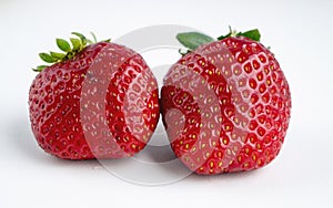 Two fresh ripe stawberries on white background