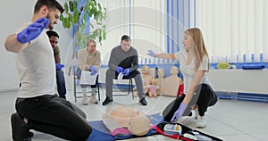 Stay away moment during the defibrillation process on a first aid group training indoors.