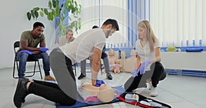 Stay away moment during the defibrillation process on a first aid group training indoors.