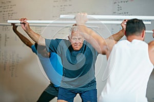 Stay fit in your senior years. a fitness group doing pvc exercises at the gym.