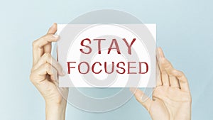 STAY FOCUSED message on the card held by