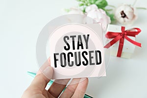 STAY FOCUSED message on the card held by