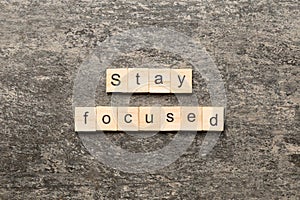 stay focused word written on wood block. stay focused text on table, concept