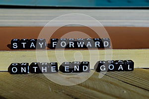 Stay forward on the end goal on wooden blocks. Motivation and inspiration concept