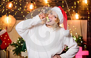 Stay healthy. Woman Santa hat eat apple fruit christmas decorations background. Diet and healthy nutrition. Christmas