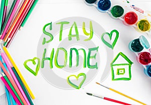 Stay at home. Children`s drawing with gouache paints on a white sheet.Campaign on social networks for the prevention of