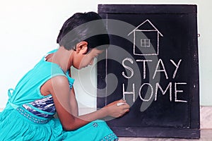 `Stay home`  concept written on blackboard.