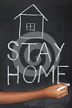 `Stay home`  concept written on blackboard.