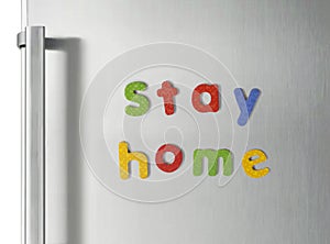 Stay Home letter magnets on refrigerator