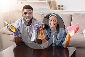 Stay At Home. Loving Black Couple Cleaning Flat Together, Wiping Dust