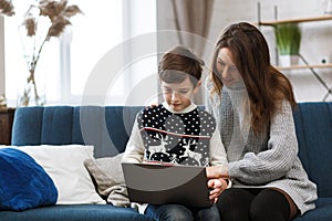 Stay home. Portrait of smiling mother and son using laptop for a online meeting, video call, video conference with