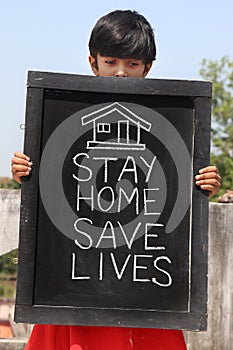 `Stay home save lives` concept written on blackboard.