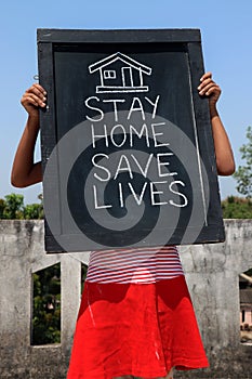 `Stay home save lives` concept written on blackboard.