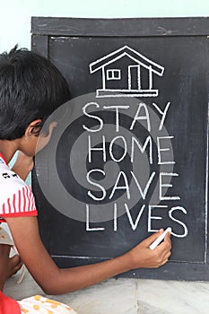 `Stay home save lives` concept written on blackboard.