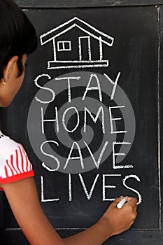 `Stay home save lives` concept written on blackboard.