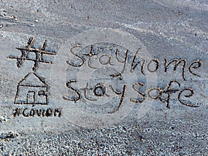 Stay home stay safe written on sand to educate people during Corona Lockdown