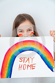 Stay home. teen girl drew rainbow and poster photo