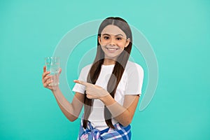 stay hydrated. kid hold glass of mineral water. child feel thirsty.