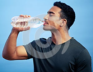 Stay hydrated so you dont lose energy. a sporty young man drinking water while exercising outdoors.