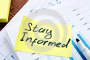 Stay Informed memo on the pile of business papers