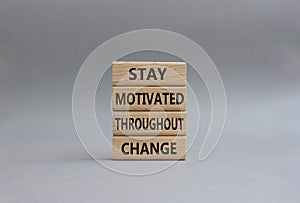 stay motivated throughout change symbol. Concept words stay motivated throughout change on wooden blocks. Beautiful grey