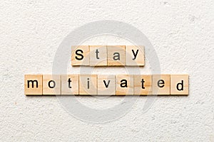 Stay motivated word written on wood block. Stay motivated text on cement table for your desing, concept