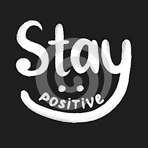 Stay positive hand drawn lettering with scratched textures. Retro inspirational phrase isolated on background. Calligraphic black