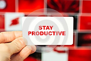 STAY PRODUCTIVE. The concept of recommendations for life. Text in the hands of a man on a red background