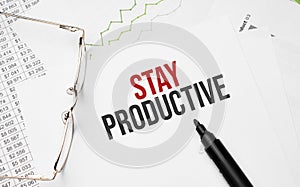 Stay Productive . Conceptual background with chart ,papers, pen and glasses