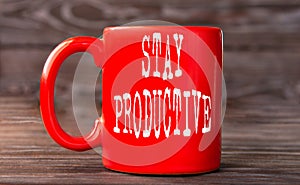 STAY PRODUCTIVE - word on a red cup on a dark background