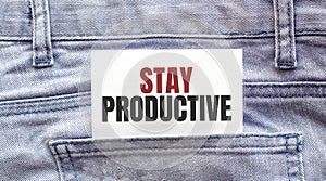 STAY PRODUCTIVE words on a white paper stuck out from jeans pocket. Business concept