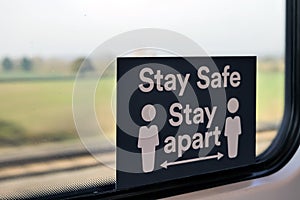 Stay safe stay apart sign on train window during covid-19 lockdown in england uk