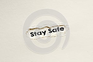 STAY SAFE word written on a white sheet. View from above