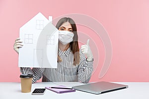 Stay safe, work at home. Woman employee sitting at workplace, wearing hygienic mask and protective gloves