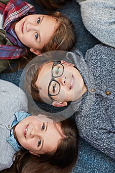 Stay in school because school is cool. elementary school kids laying on the floor at school.