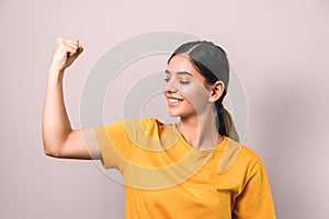 Stay strong during coronavirus pandemic. home sport time. attractive smiling brunette in yellow t-shirt showing her