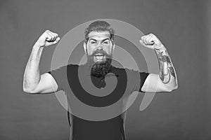 Always stay strong. Strong hipster flex arms red background. Bearded man show physical strength. Building strong biceps