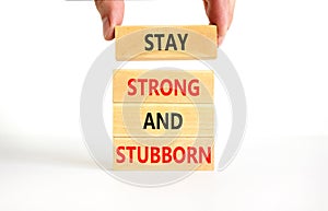 Stay strong and stubborn symbol. Concept words Stay strong and stubborn on wooden block. Beautiful white table white background.