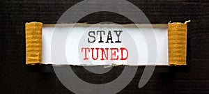 Stay tuned symbol. Concept words Stay tuned on beautiful white paper on a beautiful black background. Business, support,