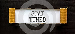 Stay tuned symbol. Concept words Stay tuned on beautiful white paper on a beautiful black background. Business, support,