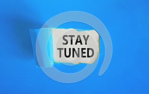 Stay tuned symbol. Concept words Stay tuned on beautiful white paper on a beautiful blue background. Business, support, motivation